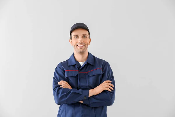 Male car mechanic on light background — Stock Photo, Image