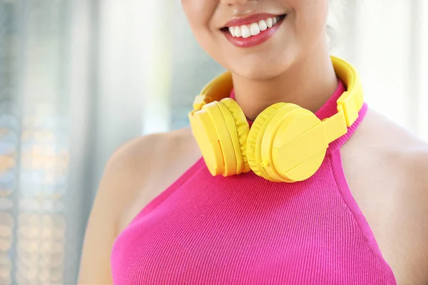 Beautiful African-American with modern headphones outdoors, closeup — Stock Photo, Image