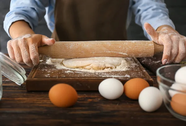 Woman rolling out dough on table, closeup — Stock Photo, Image