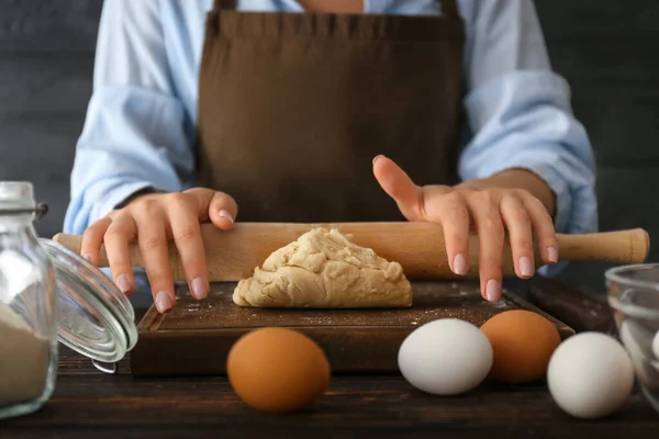 Woman rolling out dough on table, closeup — Stock Photo, Image