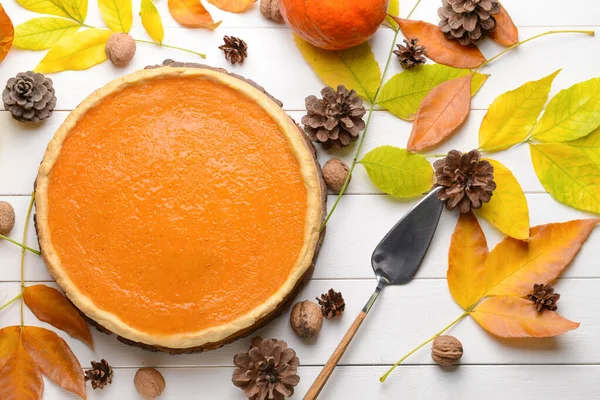 Autumn composition with tasty pumpkin pie on wooden table — Stock Photo, Image