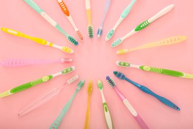 Many different tooth brushes on color background clipart
