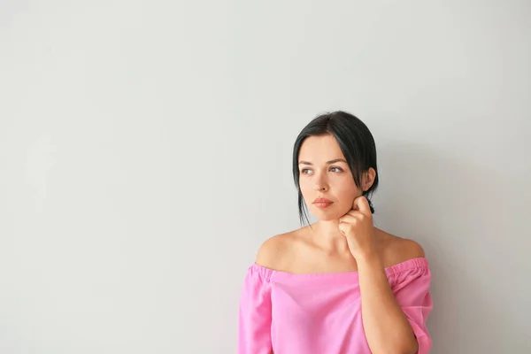 Portrait of beautiful woman on light background — Stock Photo, Image