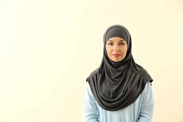 Portrait of Muslim woman on light background — Stock Photo, Image