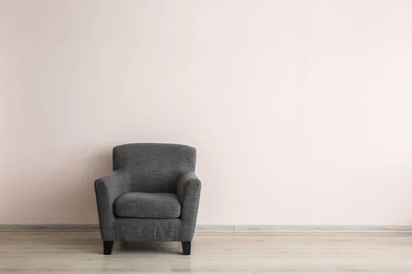 Comfortable armchair near light wall — Stock Photo, Image