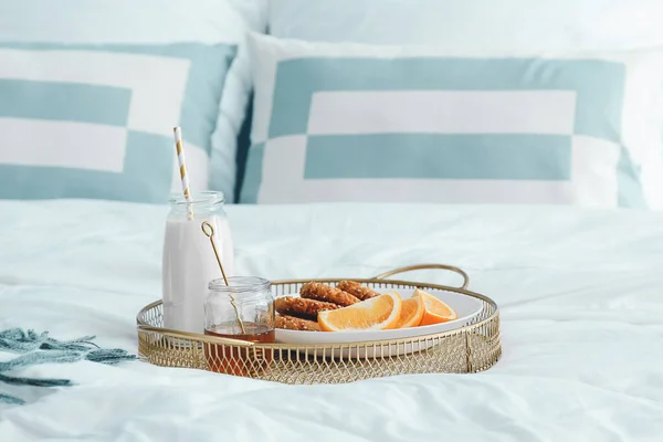 Tray with tasty breakfast on bed — Stock Photo, Image