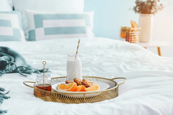 Tray with tasty breakfast on bed — Stock Photo, Image