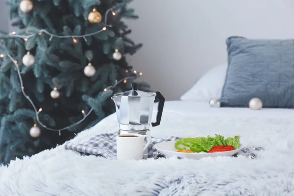 Tray with tasty breakfast in bedroom on Christmas eve — Stock Photo, Image