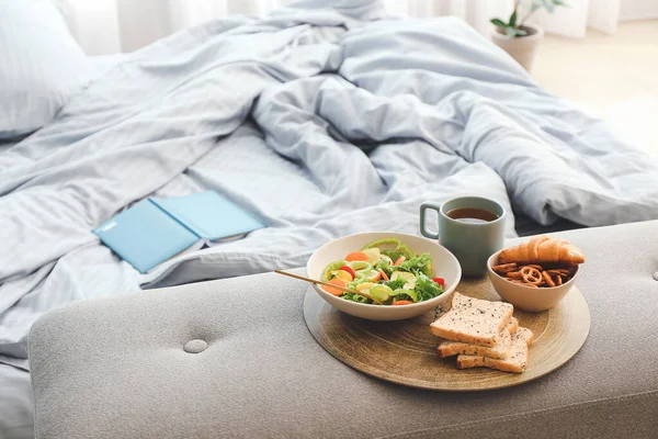 Tray with tasty breakfast in bedroom — Stock Photo, Image