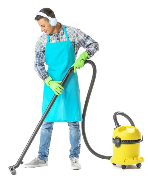 Young man with vacuum cleaner on white background — Stock Photo, Image
