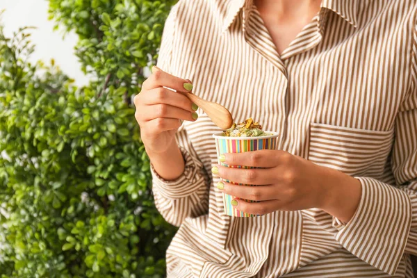 Donna che mangia gustoso gelato al pistacchio, primo piano — Foto Stock