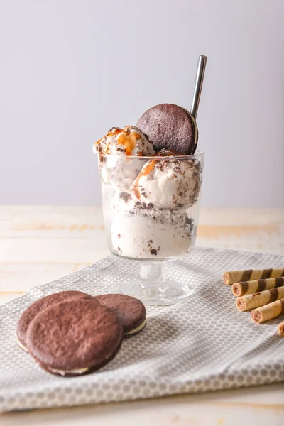 Склянка зі смачним морозивом та шоколадним печивом на столі — стокове фото