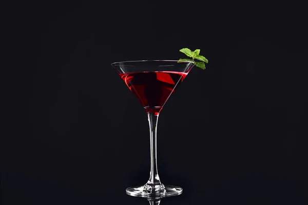 Glass of tasty cocktail on dark background — Stock Photo, Image