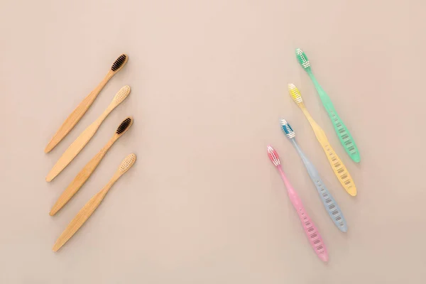 Different tooth brushes on color background — Stock Photo, Image