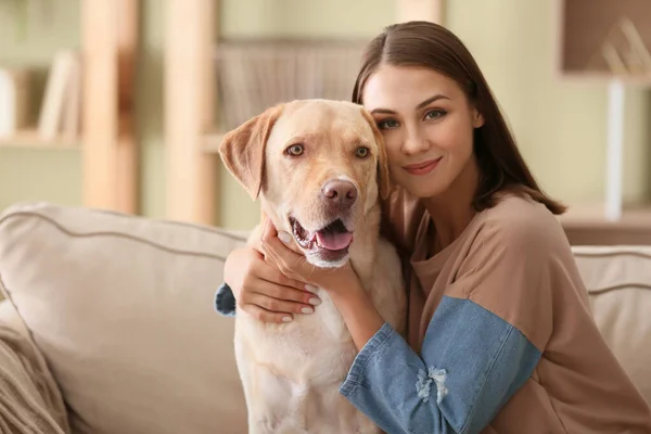 Beautiful young woman with cute dog at home — Stock Photo, Image
