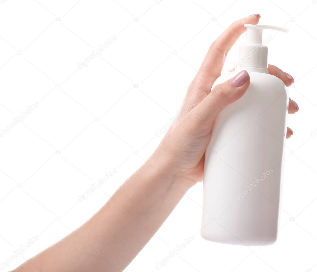 Female hand with bottle of cosmetics on white background