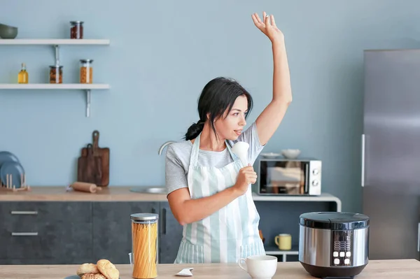 Beautiful woman having fun while cooking in kitchen — Stock Photo, Image