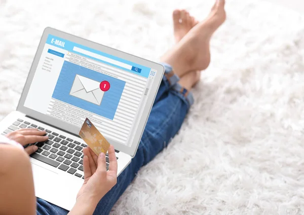 Young woman with laptop checking an email at home — Stock Photo, Image