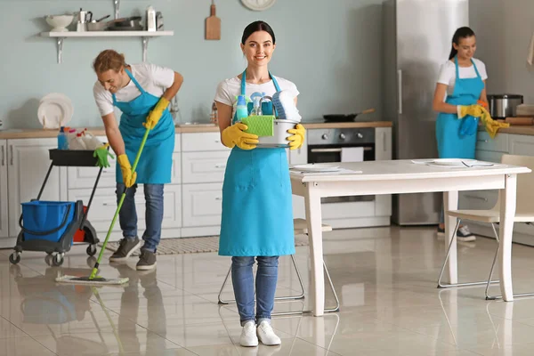 Team of janitors cleaning kitchen — ストック写真