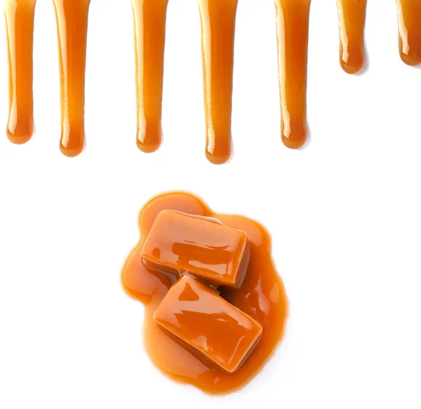 Tasty caramel candies and stains on white background — Stock Photo, Image