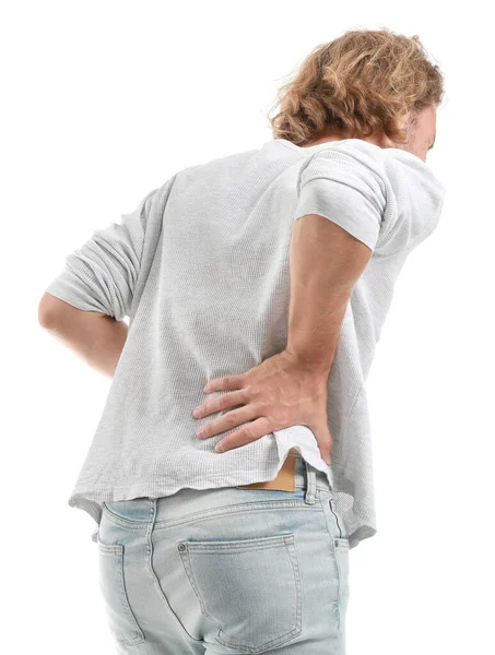 Young man suffering from back pain on white background — Stock Photo, Image