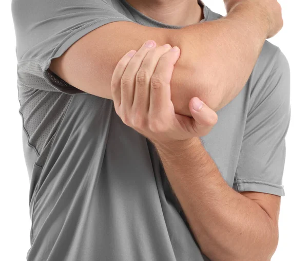 Young man suffering from pain in elbow on white background, closeup — Stock Photo, Image