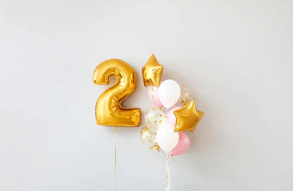 Figure 2 and different balloons on light background — Stock Photo, Image