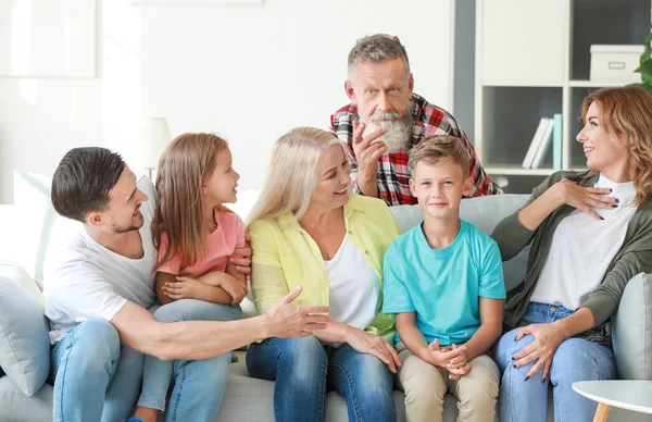 Big family sitting together on couch at home — ストック写真