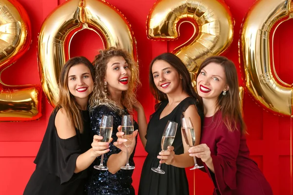 Beautiful young women drinking champagne at Christmas party Stock Image