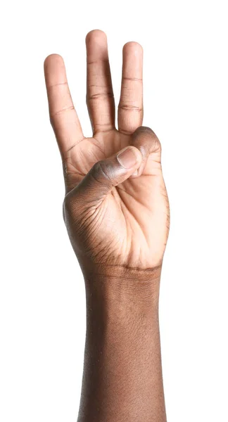 Hand of African-American man showing three fingers on white background — ストック写真