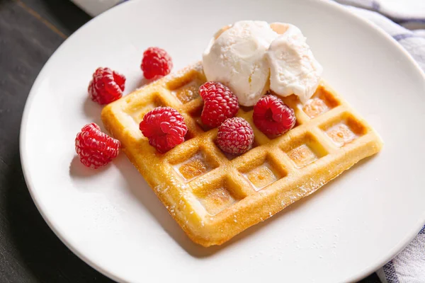 Tasty waffle with ice-cream and berries on plate, closeup — Stock Photo, Image