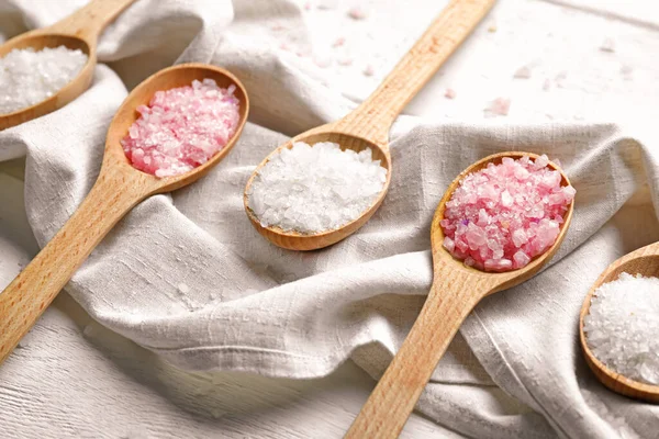 Spoons with sea salt for spa procedures on table — Stock Photo, Image