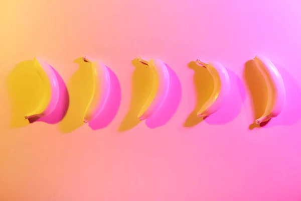 Ripe painted bananas on color background — Stock Photo, Image