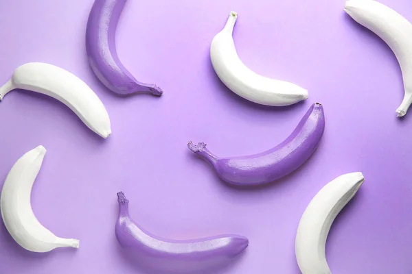 Ripe painted bananas on color background — Stock Photo, Image