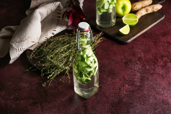 Bottle of healthy infused water on table — Stock Photo, Image