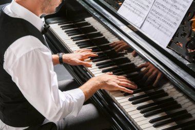 Konserde kuyruklu piyano çalan adam