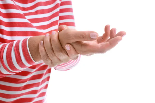 Mature woman suffering from pain in wrist on white background, closeup — Stock Photo, Image