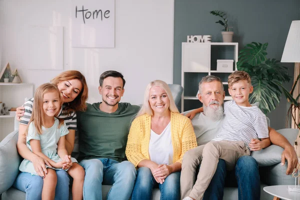 Big family sitting together on couch at home — Stock Photo, Image