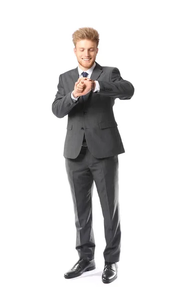 Portrait of handsome businessman looking a his watch on white background — Stock Photo, Image