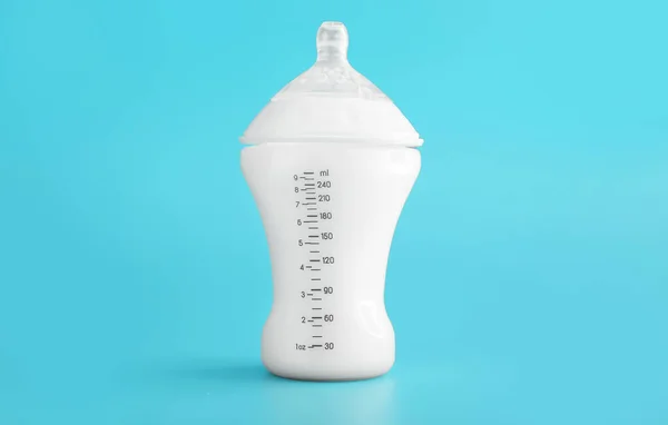 Bottle of milk for baby on color background — Stock Photo, Image