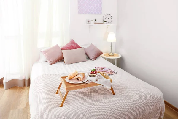 Tray with tasty breakfast on bed — Stock Photo, Image