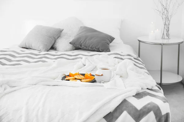 Tray with tasty breakfast on bed — Stock Photo, Image