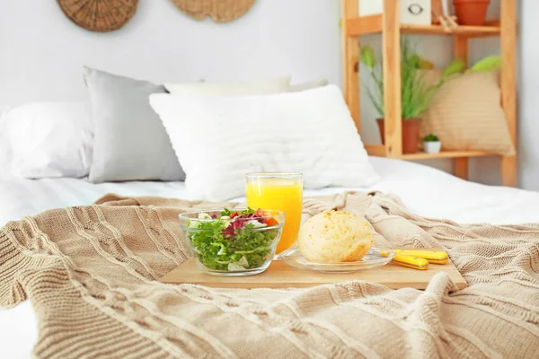 Tray with tasty breakfast on bed — Stock Photo, Image