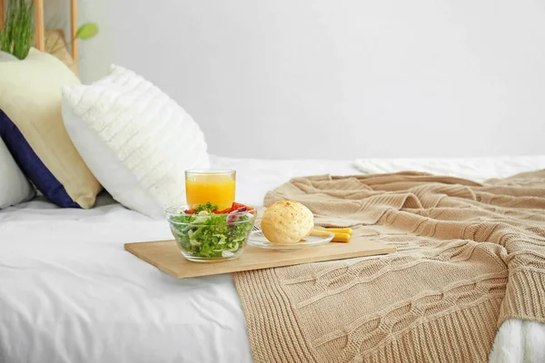 Tray with tasty breakfast on bed — Stock Photo, Image