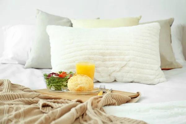 Tray with tasty breakfast on bed — Stock Photo, Image