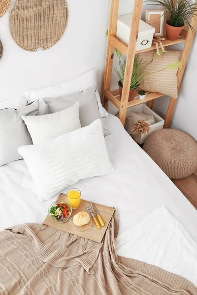 Interior of modern bedroom with breakfast on bed — Stock Photo, Image