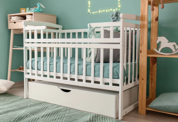 Stylish baby bed in interior of children's room — Stock Photo, Image