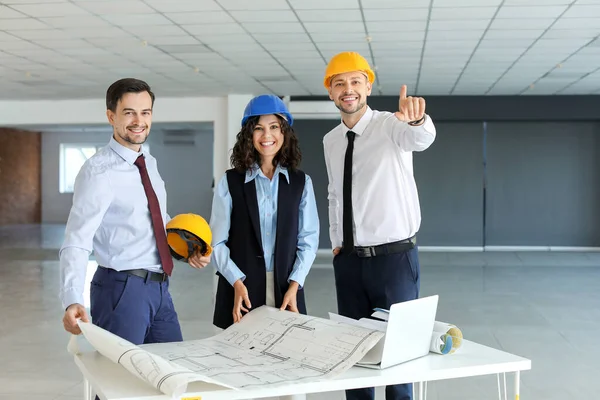 Equipo de ingenieros discutiendo proyecto de construcción en interiores — Foto de Stock