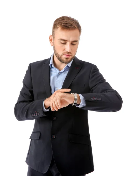 Portrait of handsome businessman looking at watch on white background — Stock Photo, Image