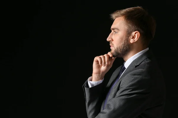 Portrait of handsome businessman on dark background — Stock Photo, Image